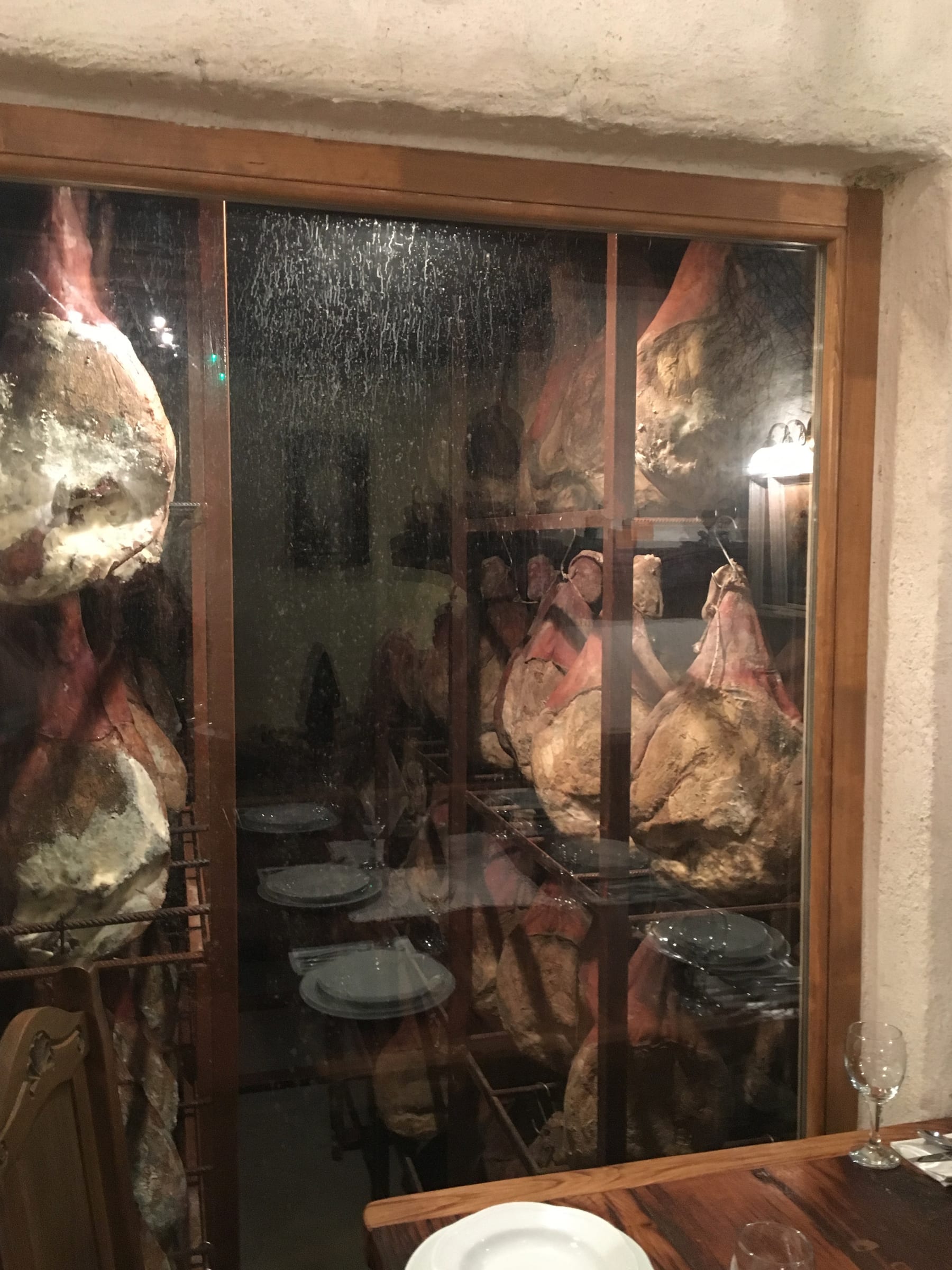 A photo of the meat hanging and aging in the cellar at Roca